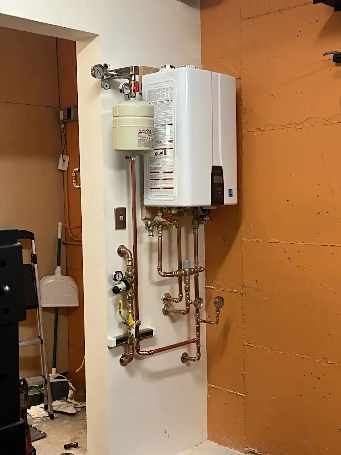 Plumbing technician inspecting water heater connections in East Pasadena